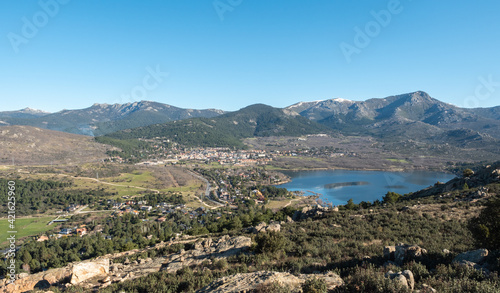 View of the lake and the village of Navacerrada Madrid with the Sierra de Guadarrama in the background - Siete Picos - Bola del Mundo - La Maliciosa photo