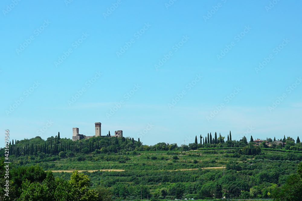 Medieval Italian castle built in a valley.
Towers of an ancient castle among the vegetation of the countryside.