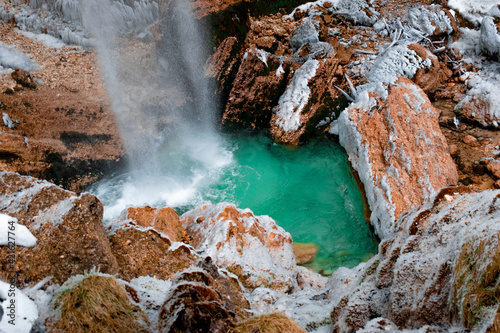 Geothermal winter waterfal in the mountains photo