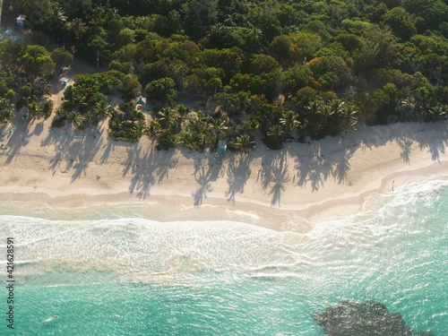 Aerial view of the pristine waters and white sand Flamenco Beach