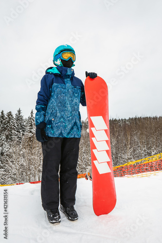 Person with a snowboard on the ski resort photo