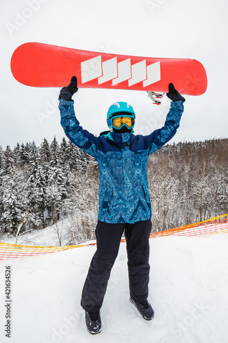 Person with a snowboard on the ski resort photo