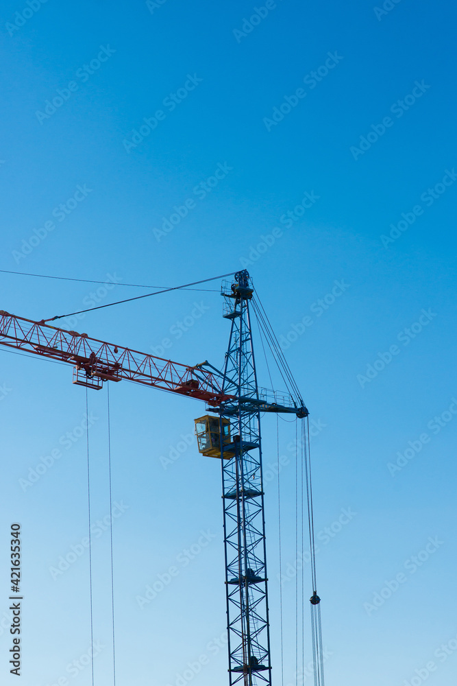 High factory structure and tower crane at industrial production area.