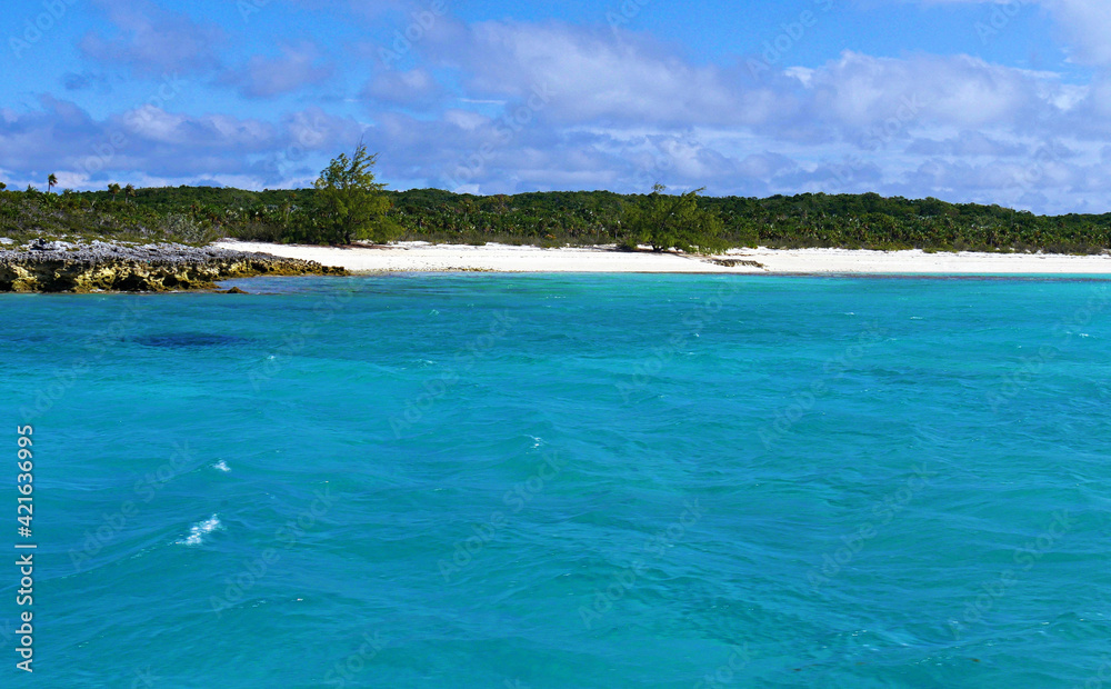 Clear blue waters of Exuma Cays with white-sand beaches, Bahamas.