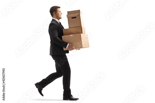 Full length profile shot of a businessman walking and carrying boxes © Ljupco Smokovski