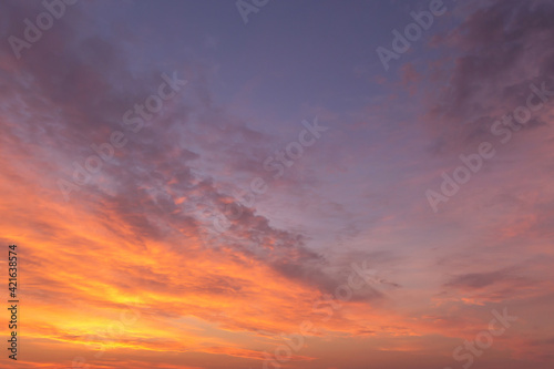 Sunrise, sunset pink blue orange sky in sunlight with cirrus clouds background texture
