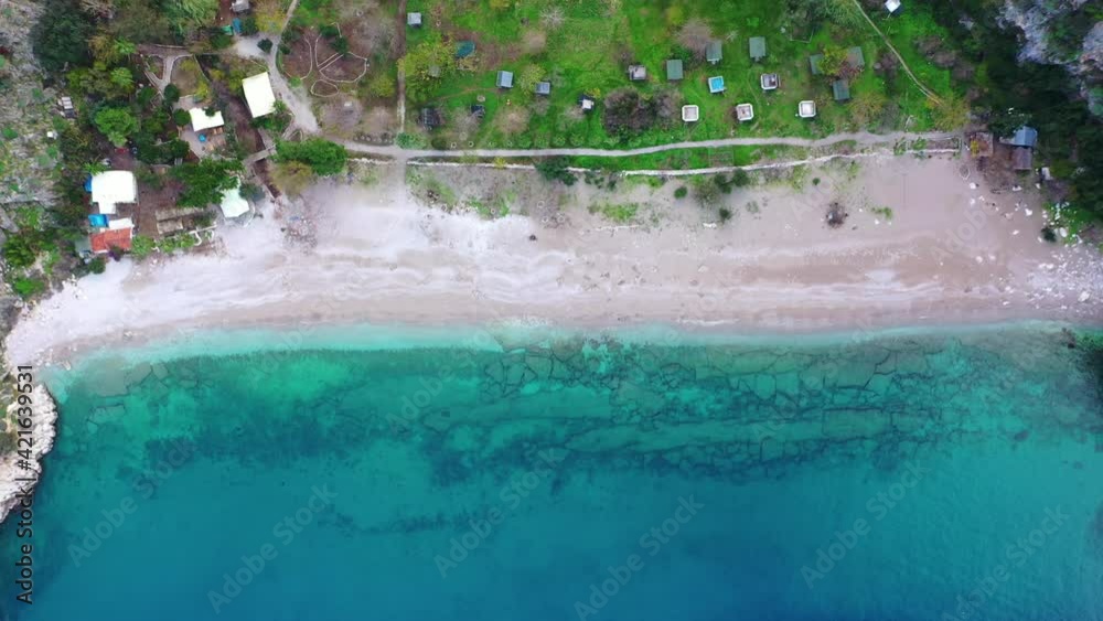 A beautiful, panoramic shot taken by a drone that captures Kelebekler valley. This scenery's vivid colors, its sea and its forest full of green trees create a marvellous view that is pleasing to eye. A beautiful, panoramic shot taken by a drone that captures Kelebekler valley. This scenery's vivid colors, its sea and its forest full of green trees create a marvellous view that is pleasing to eye.