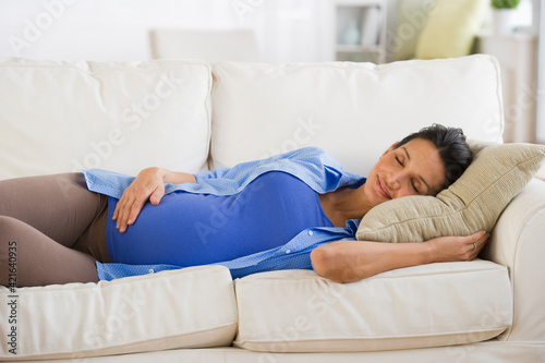 Pregnant woman napping on couch