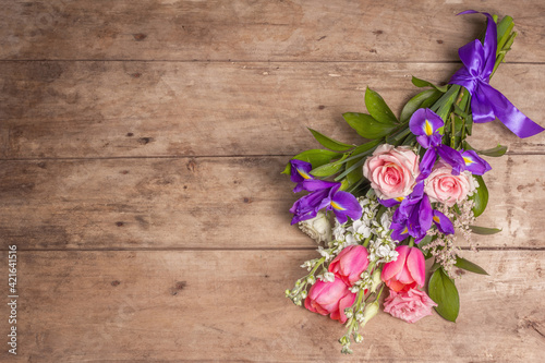 A beautiful bouquet of wedding flowers on old wooden boards