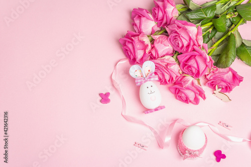 Traditional Easter symbols concept with cute rabbit from an egg, festive decor and gentle roses © FuzullHanum