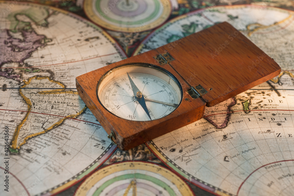 Antique compass on map