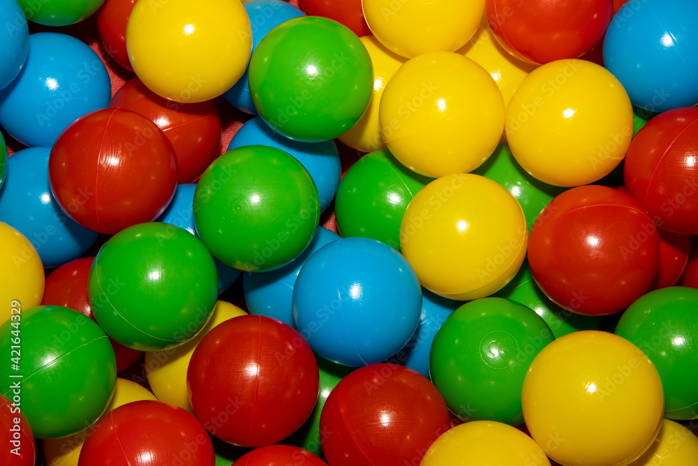 A close up of a bunch of colourful plastic balls in a children's ball pool pit A close up of a bunch of colourful plastic balls in a children's ball pool pit