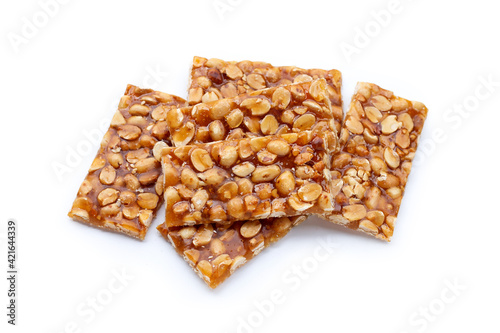 Honey bars with peanuts on white background
