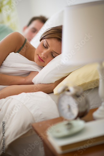 USA, New Jersey, Jersey City, Young couple sleeping in bed