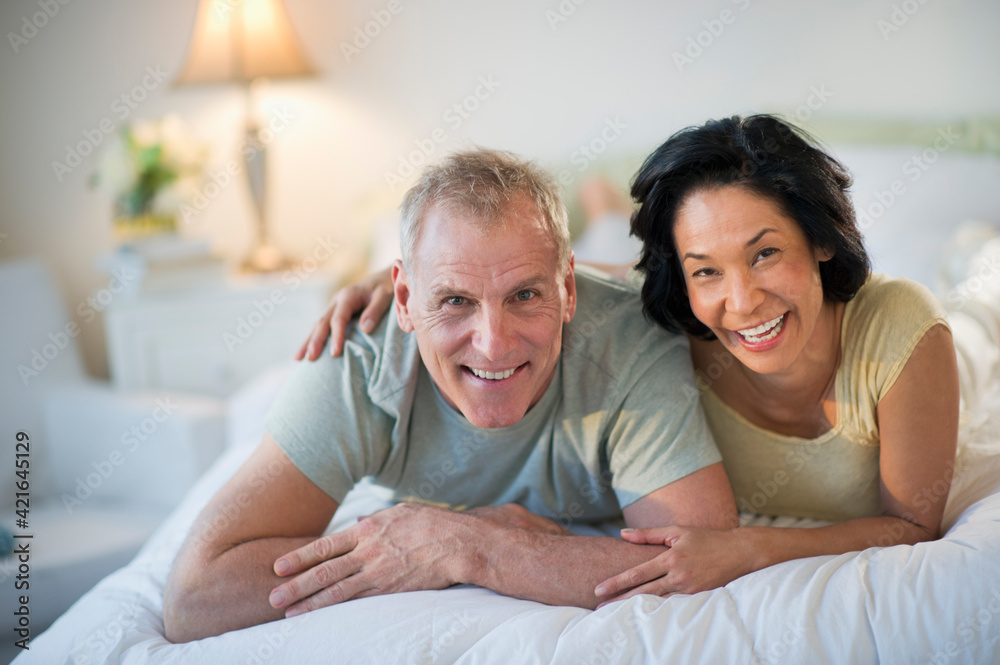Happy mature couple laying in bed Happy mature couple laying in bed