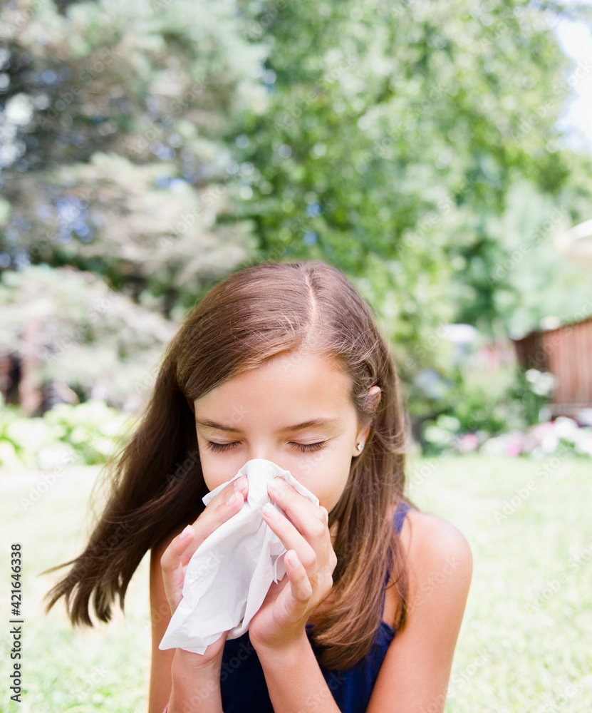 USA, New York, Girl (10-11) blowing nose USA, New York, Girl (10-11) blowing nose