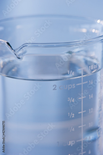 Measuring cup full of water photo