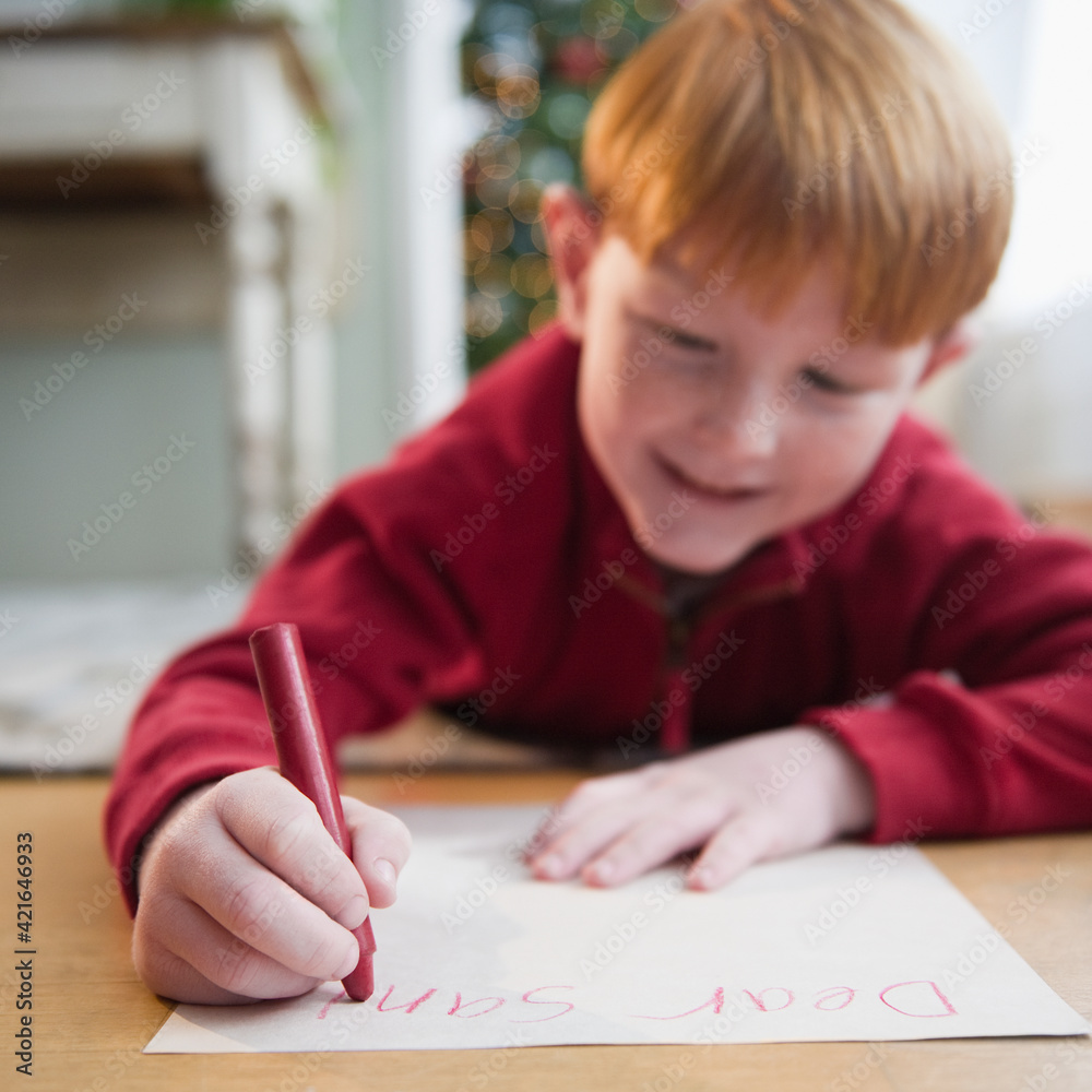 Boy (8-9) writing letter to Santa Boy (8-9) writing letter to Santa