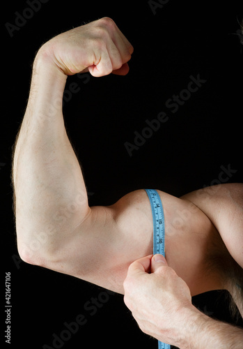 Man measuring his bicep photo