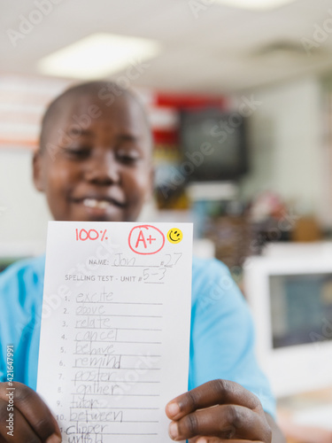 Elementary student holding an A grade paper photo