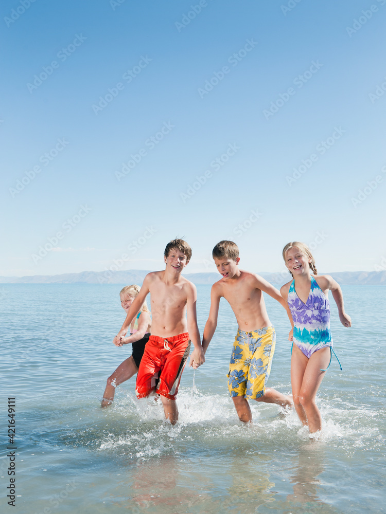 Kids (6-7,8-9,10-11,12-13) playing in lake Kids (6-7,8-9,10-11,12-13) playing in lake