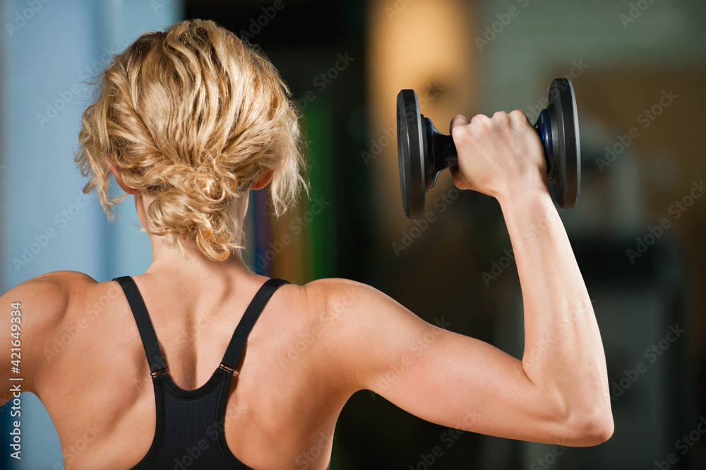 USA, California, Los Angeles, woman exercising with dumbbells USA, California, Los Angeles, woman exercising with dumbbells