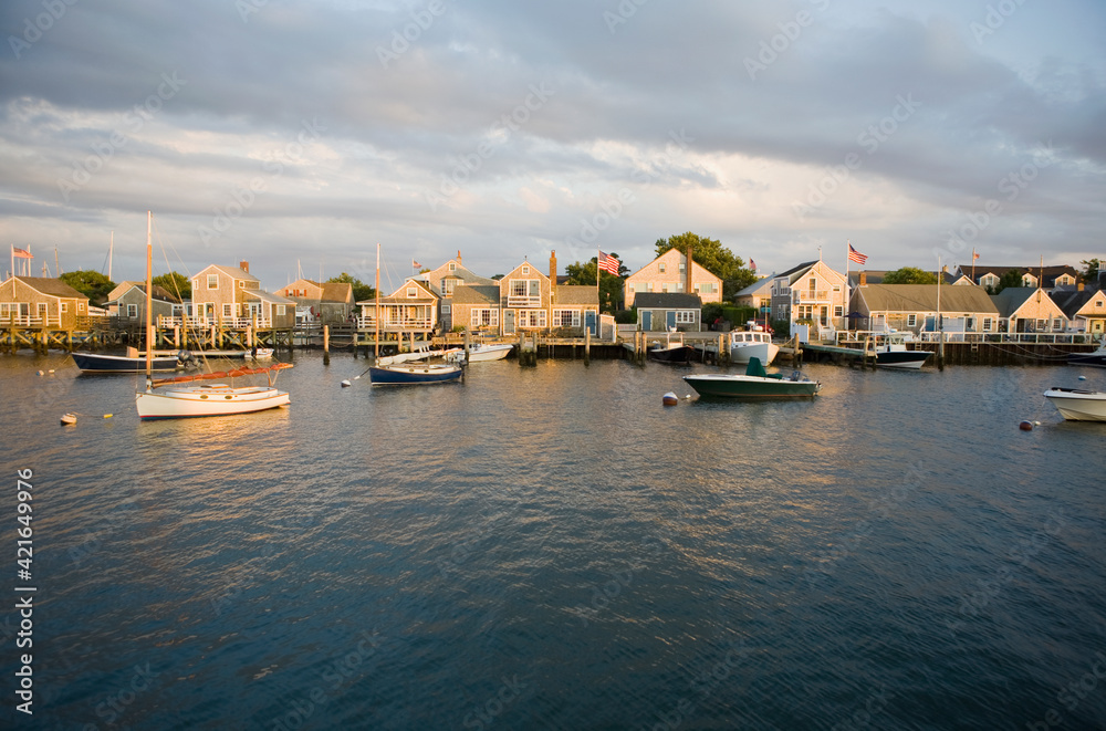Boats in harbor with village in background Boats in harbor with village in background