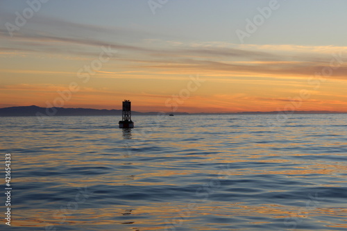 silhouette of a buoy at sunset © Patrick