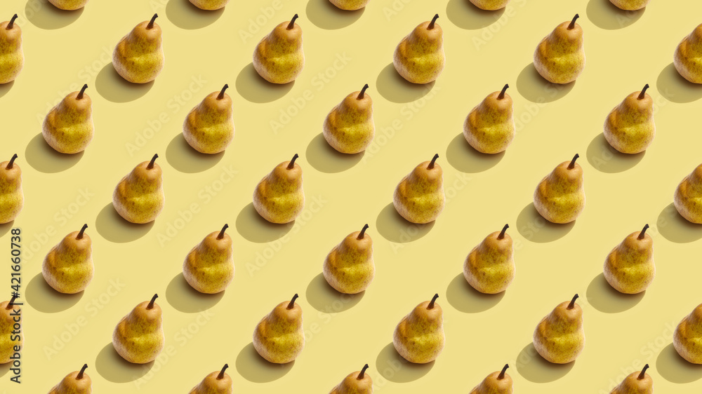 Background from fruit pattern. Bright fruit pattern of fresh pears on yellow background. Top view