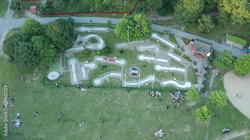 Miniature golf course in Stockholm, Sweden. Beautiful summer evening. Park with people picnicking.