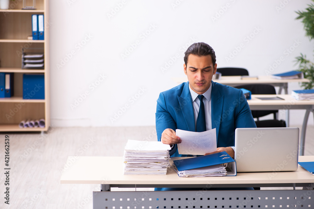 Young businessman employee reading contract in the office Young businessman employee reading contract in the office