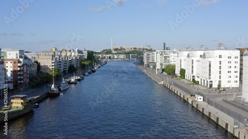 Stockholm, Sweden, Scandinavia. Aerial Drone summer view above a peaceful canal and bay at Hammarby Sjöstad with modern architecture, marina, old vintage boats.