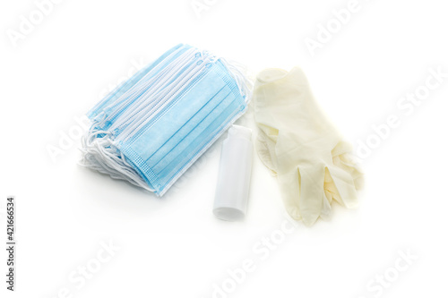 Medical masks, disposable gloves and antiseptic in a bottle close-up