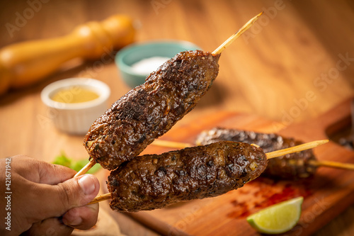 Beef kafta on the wooden board. Kafta, Traditional Arabic cuisine. photo