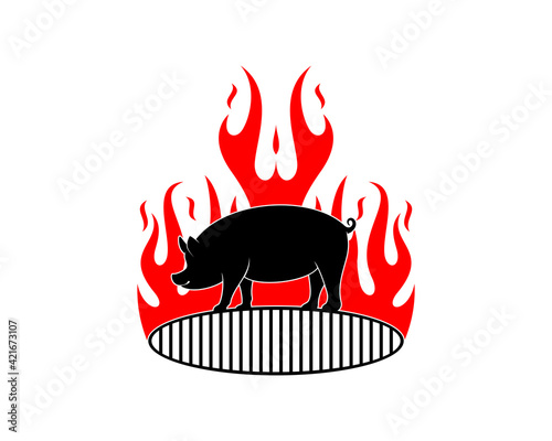 Standing pig on the grill pan with fire flame behind