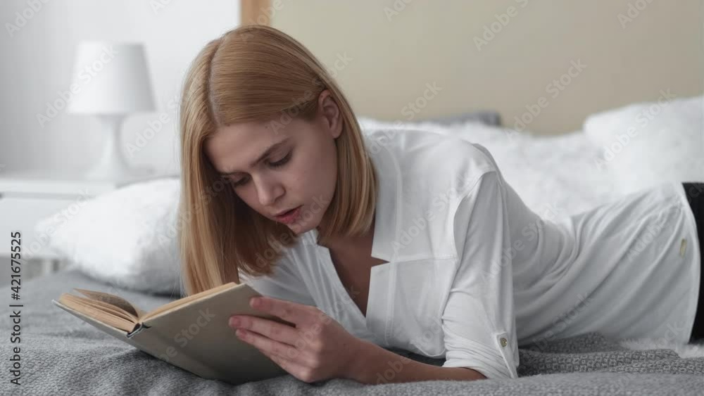 Morning book. Reading hobby. Home leisure. Curious relaxed inspired woman enjoying time with favorite romantic novel in cozy bed at weekend finished chapter satisfied leaving light bedroom. Morning book. Reading hobby. Home leisure. Curious relaxed inspired woman enjoying time with favorite romantic novel in cozy bed at weekend finished chapter satisfied leaving light bedroom.