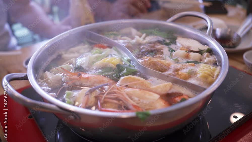 Shabu shabu or sukiyaki japanese style food , Half pot hot boiling and vegetable and pork Shabu shabu or sukiyaki japanese style food , Half pot hot boiling and vegetable and pork