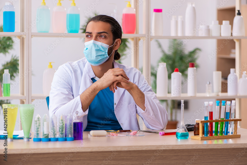 Young male chemist testing soap in the lab Young male chemist testing soap in the lab