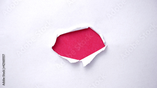 Paper torn from center with pink background
 photo