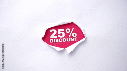 Torn paper hole in the white wall and a pink background with text "25% DISCOUNT" inside 