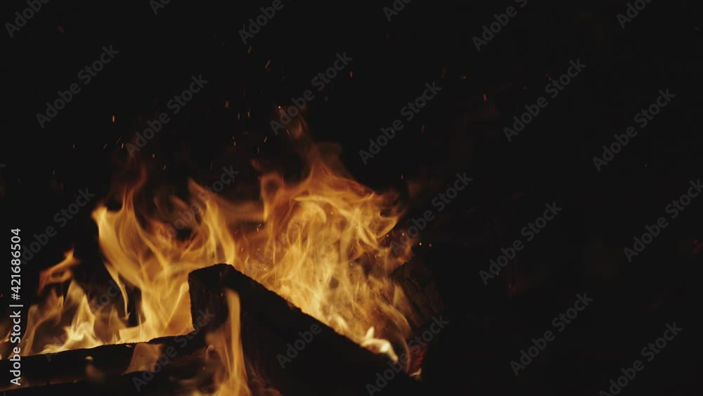 Closeup of campfire flames burning a pile of wood logs. Closeup of campfire flames burning a pile of wood logs.