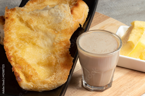 Typical Brazilian breakfast know as pão na chapa (bread toasted with butter) and pingado (milk mixed with coffee). photo