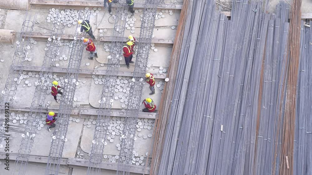 Top aerial view of construction workers work in project building area ...