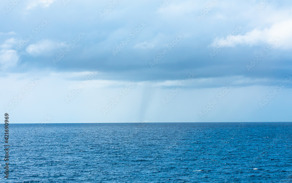 landscape view of sea spout (water tornado) in the south Pacific Ocean.