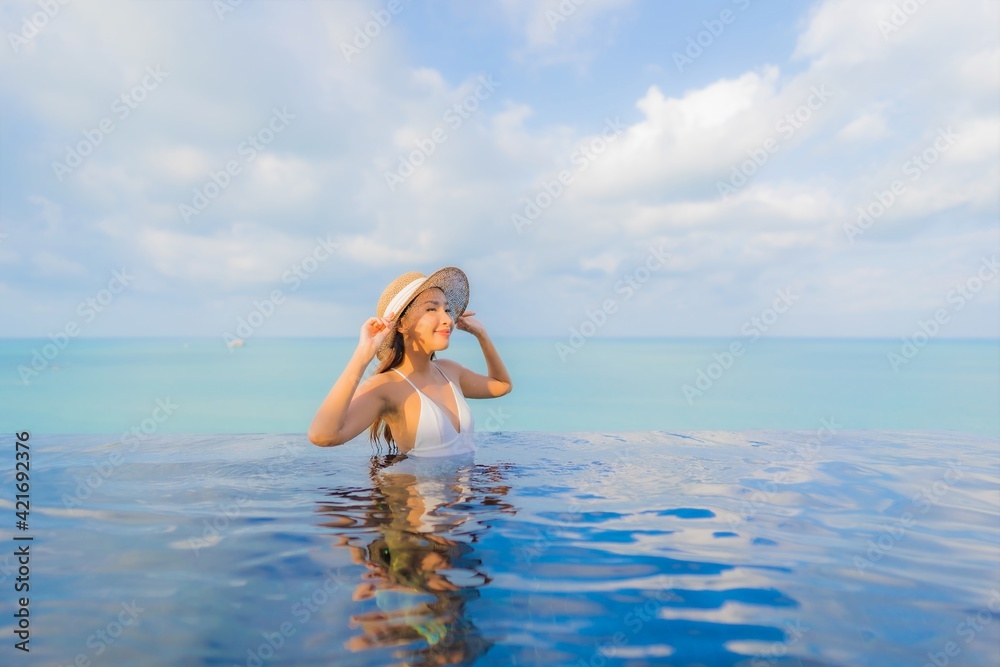 Portrait beautiful young asian woman relax smile leisure around outdoor swimming pool