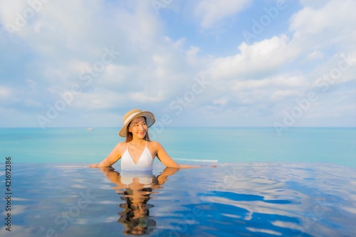 Portrait beautiful young asian woman relax smile leisure around outdoor swimming pool