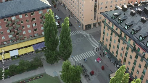 Stockholm, Sweden, Scandinavia. Panoramic aerial flying drone view above the square, Nytorget, Södermalm. Summer evening people hanging out. photo