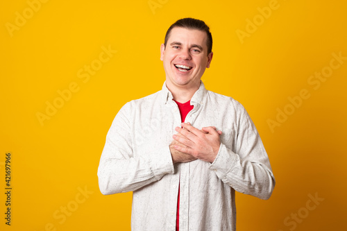 Handsome man wearing casual clothes smiling with hands on chest with closed eyes and grateful gesture on face.