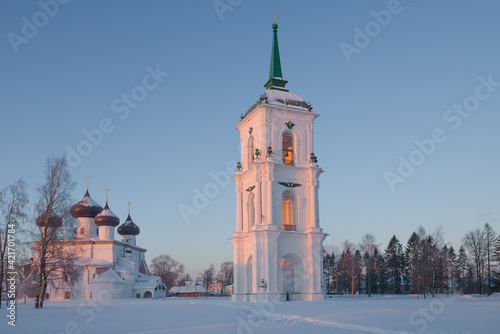 Ancient bell tower and Nativity Cathedral on Cathedral Square on February morning. Kargopol, Russia photo