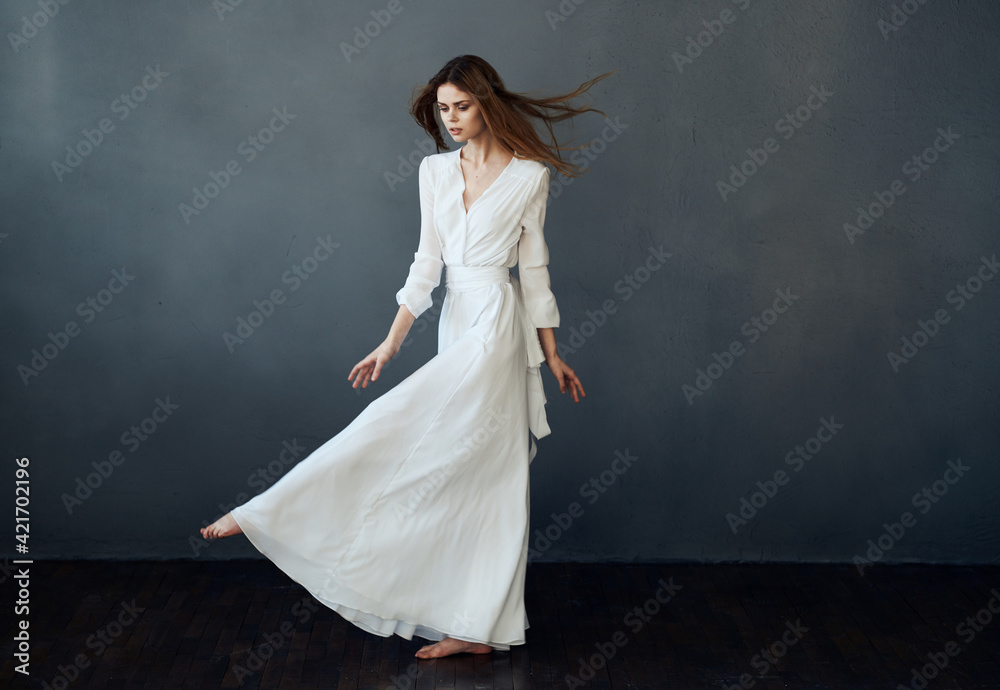 Woman in white dress dance performance luxury glamor gray background Woman in white dress dance performance luxury glamor gray background